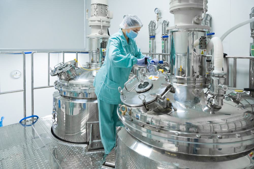 Employee working in with a pharmaceutical reactor