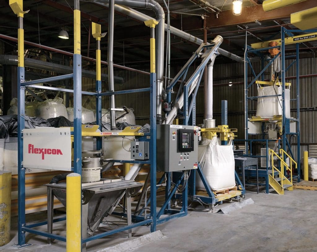 Two bulk bag dischargers, a flexible screw conveyor, a bulk bag filler and programmable controls allow re-bagging of PVC modifiers into bulk bags of three sizes and 23 kg sacks, efficiently and dust-free.